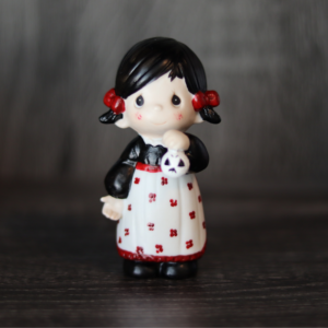 Repainted Precious Moments Doll (an Unprecious Moments Doll) of a little girl holding a skull
