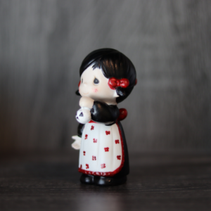 Repainted Precious Moments Doll (an Unprecious Moments Doll) of a little girl holding a skull
