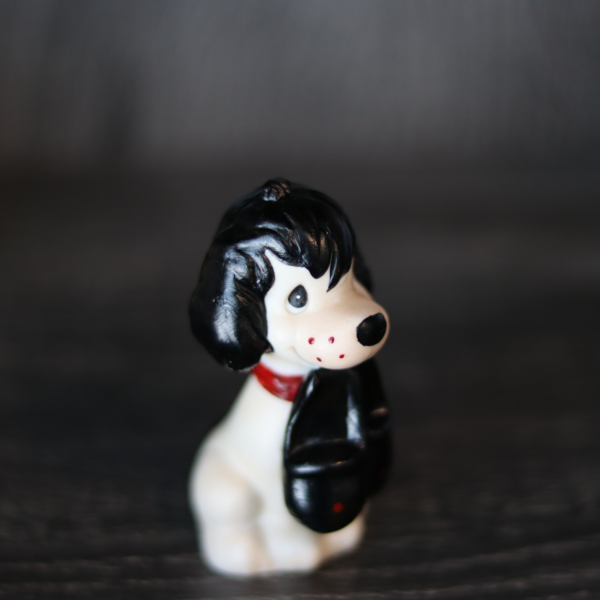 Repainted Precious Moments Doll (an Unprecious Moments Doll) of a dog holding slippers pictured from above