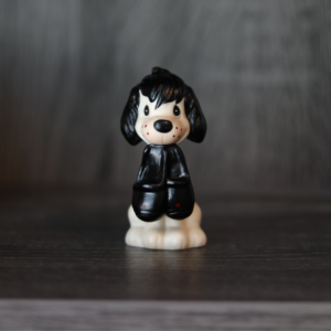 Repainted Precious Moments Doll (an Unprecious Moments Doll) of a dog holding slippers